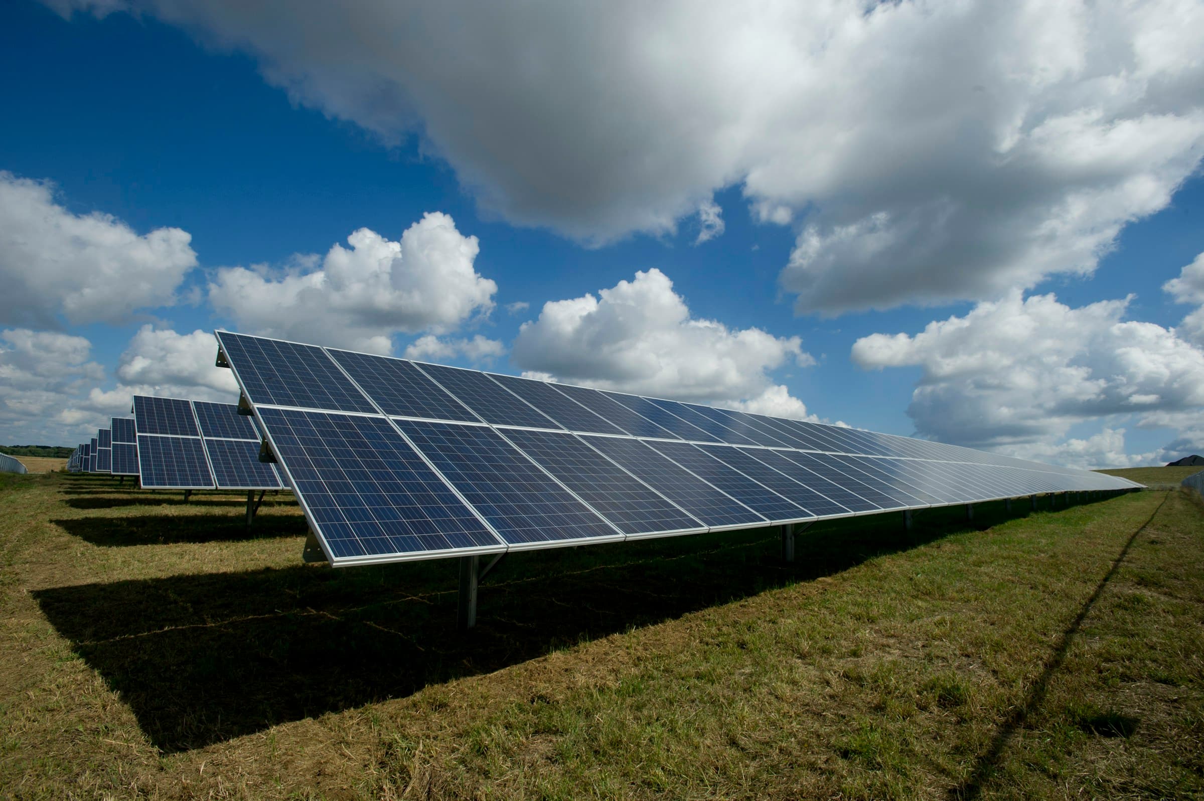 Solar photovoltaic panels in a field under a clear sky, energy and utilities